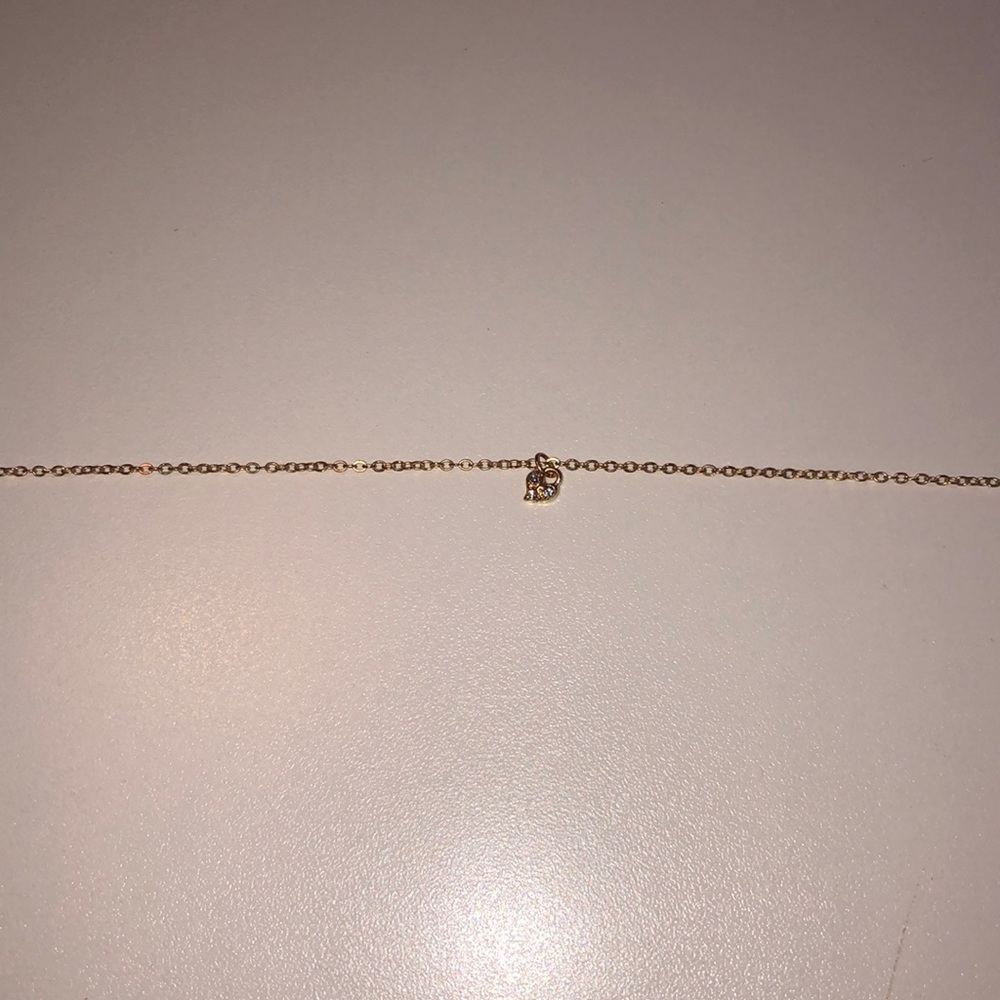 This is a gold necklace with a heart
